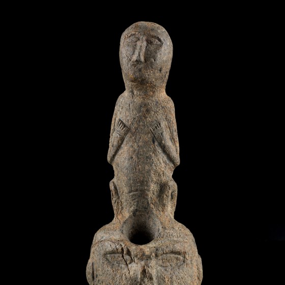 Stone figure of human on human head