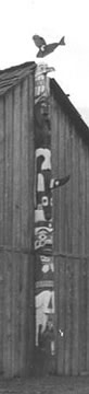 Close up of totem pole with eagle figure on top