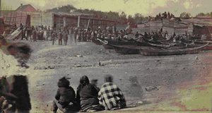 Potlatch dans l'Ancienne Réserve songhees en 1869. Les maisons longues sont construites dans le style traditionnel des Salishs de la Côte. 
