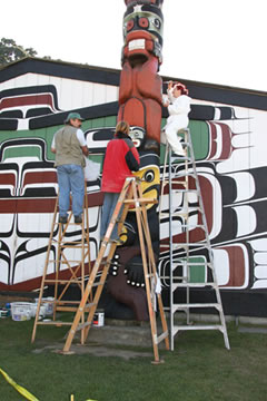 George Field, Megan Anderson et Colleen Wilson repeignant un mât totémique du parc Thunderbird