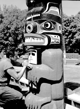 David Martin painting a front house post