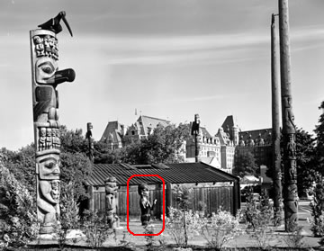 Naxalk figure with other totem poles in Thunderbird Park