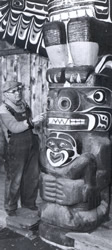 Henry Hunt putting the finishing touches on the Expo 67 pole at the carving shed