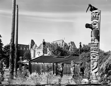 View of Totem Poles in Thunderbird Park with the Empress Hotel in the background.