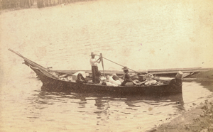 A family in Victoria harbour departs for a trip with their belongings in a Nuu-chah-nulth style canoe