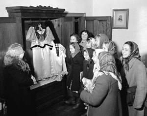 School class visiting Helmcken House in 1949. Mr Flucke is showing the medical Chest.