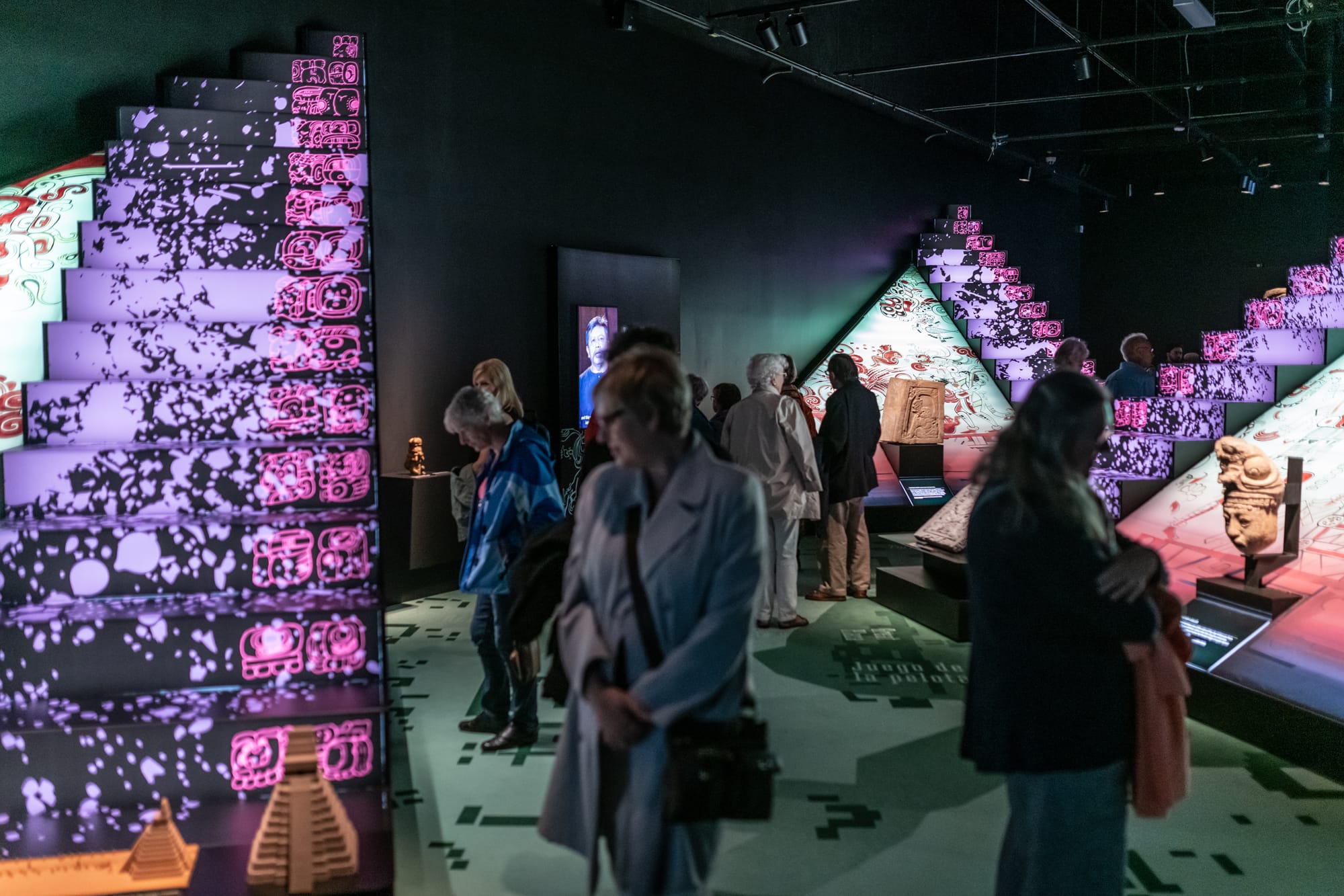 People looking at Maya: The Great Jaguar Rises exhibit.